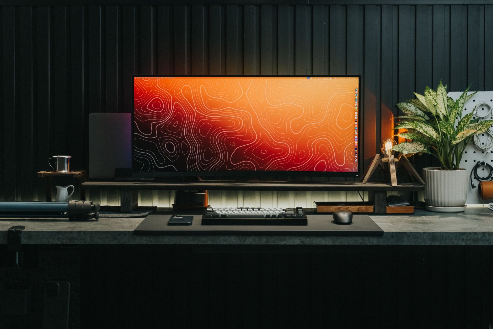 A sleek, organized gaming desk setup featuring a modern monitor and keyboard — clean, calm, ready